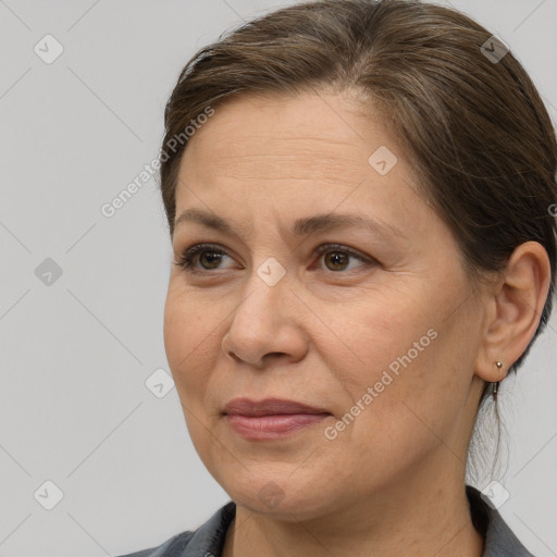 Joyful white adult female with medium  brown hair and brown eyes