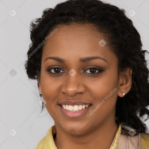 Joyful black young-adult female with long  brown hair and brown eyes