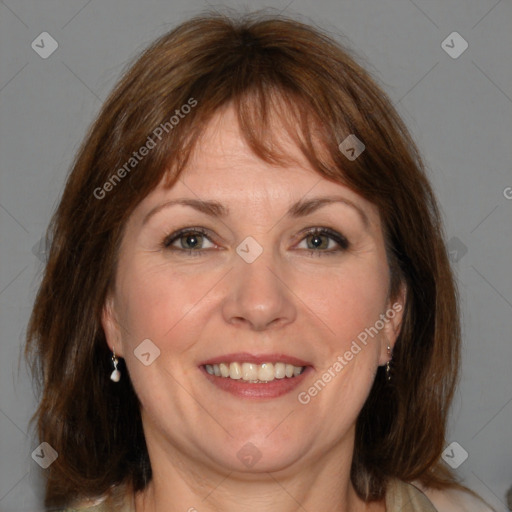 Joyful white adult female with medium  brown hair and blue eyes