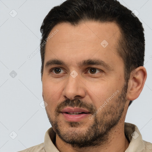 Joyful white adult male with short  black hair and brown eyes