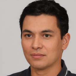 Joyful white young-adult male with short  black hair and brown eyes