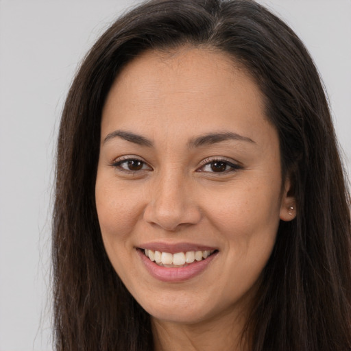 Joyful white young-adult female with long  brown hair and brown eyes