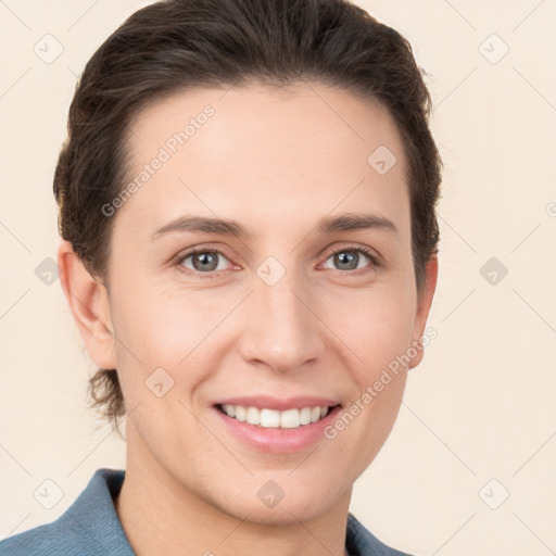 Joyful white young-adult female with short  brown hair and grey eyes