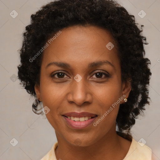 Joyful black adult female with short  brown hair and brown eyes