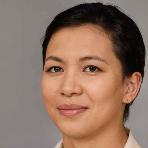 Joyful asian adult female with short  brown hair and brown eyes