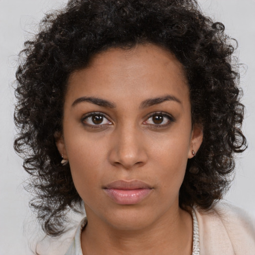 Neutral black young-adult female with long  brown hair and brown eyes