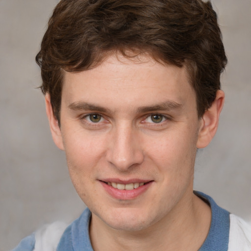 Joyful white young-adult male with short  brown hair and blue eyes