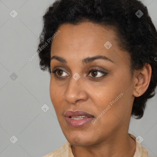 Joyful black adult female with short  brown hair and brown eyes