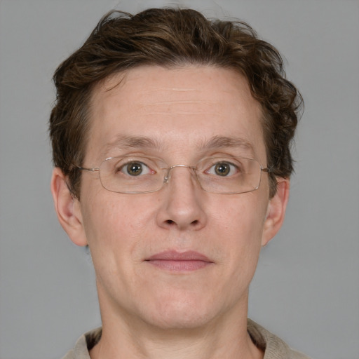 Joyful white adult male with short  brown hair and grey eyes