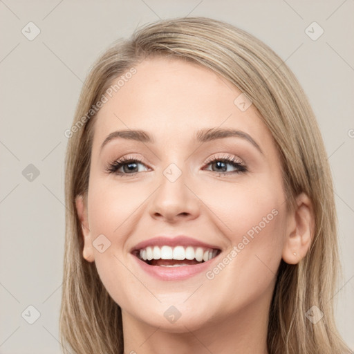 Joyful white young-adult female with long  brown hair and green eyes