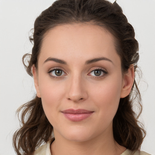 Joyful white young-adult female with medium  brown hair and green eyes