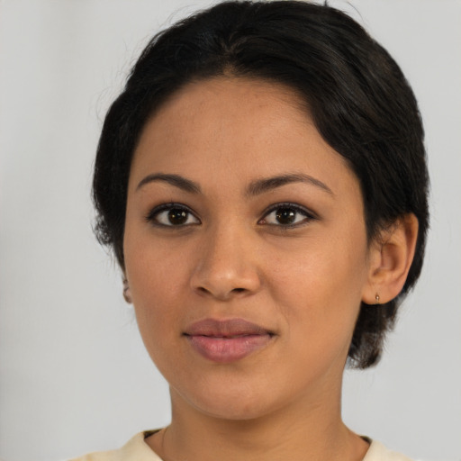 Joyful latino young-adult female with short  black hair and brown eyes