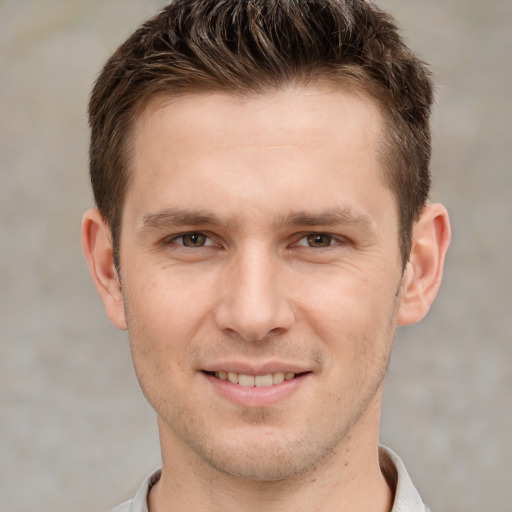 Joyful white young-adult male with short  brown hair and grey eyes