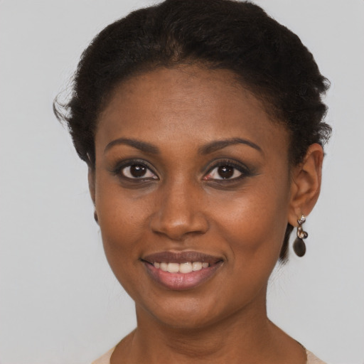 Joyful black young-adult female with short  brown hair and brown eyes