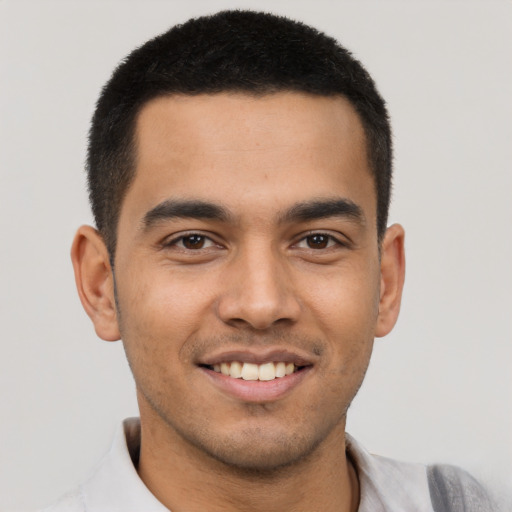 Joyful latino young-adult male with short  brown hair and brown eyes