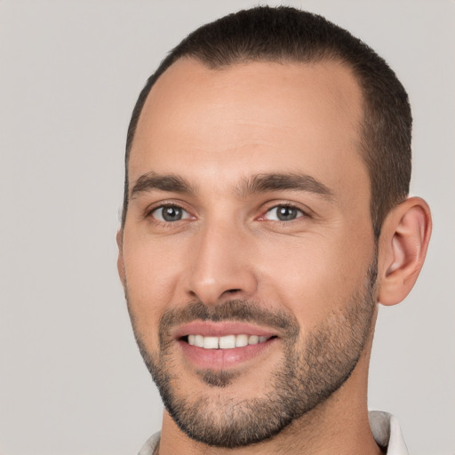 Joyful white young-adult male with short  black hair and brown eyes