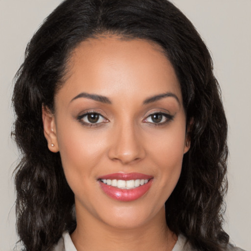 Joyful white young-adult female with long  black hair and brown eyes