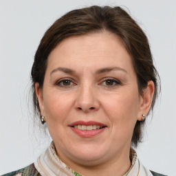 Joyful white adult female with medium  brown hair and grey eyes