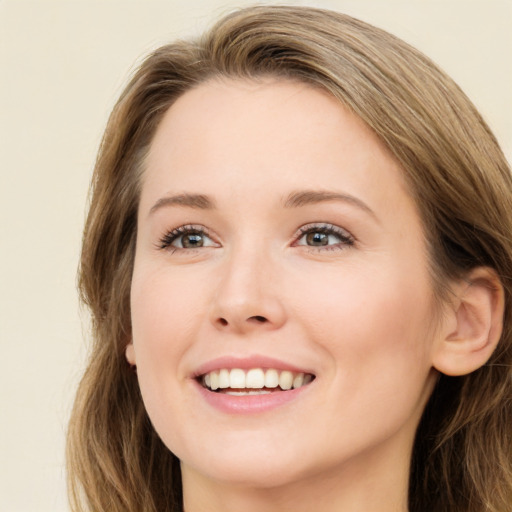 Joyful white young-adult female with long  brown hair and green eyes