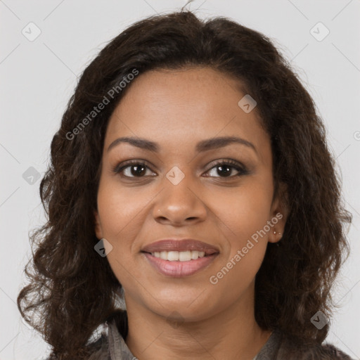 Joyful black young-adult female with long  brown hair and brown eyes