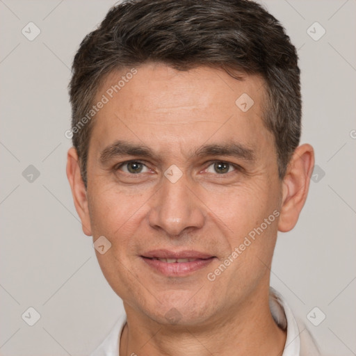 Joyful white adult male with short  brown hair and brown eyes