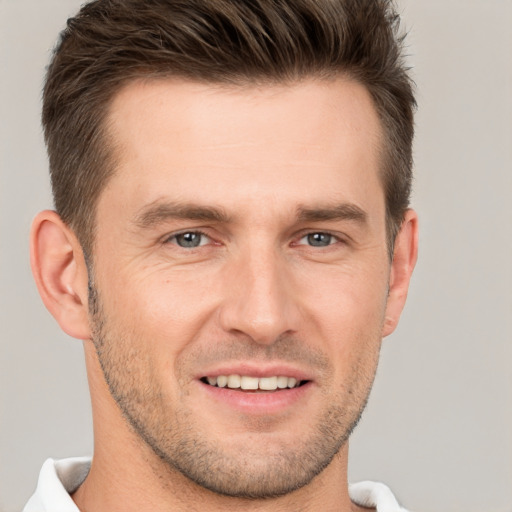 Joyful white young-adult male with short  brown hair and brown eyes