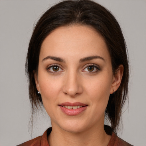 Joyful white young-adult female with medium  brown hair and brown eyes