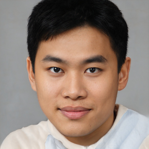 Joyful asian young-adult male with short  brown hair and brown eyes