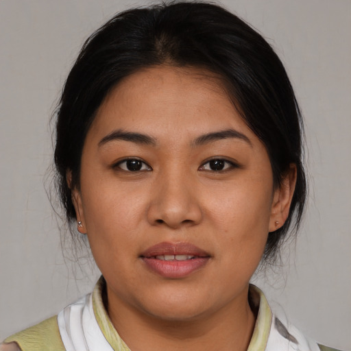 Joyful latino young-adult female with medium  brown hair and brown eyes