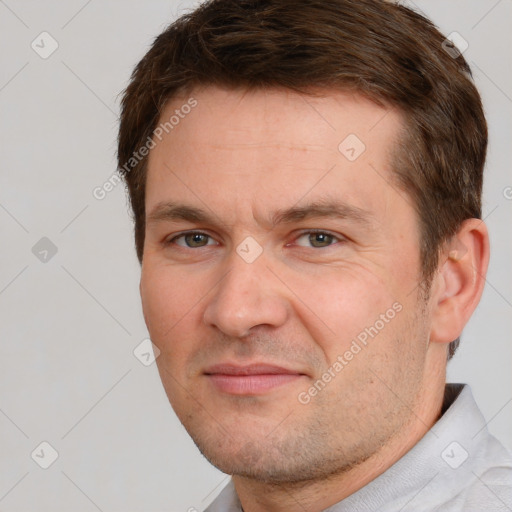 Joyful white adult male with short  brown hair and brown eyes