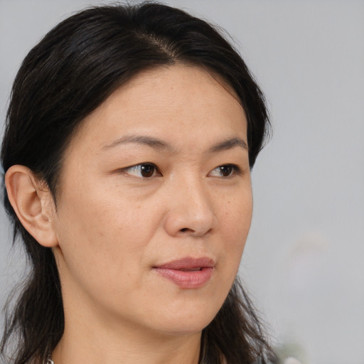 Neutral asian adult female with medium  brown hair and brown eyes