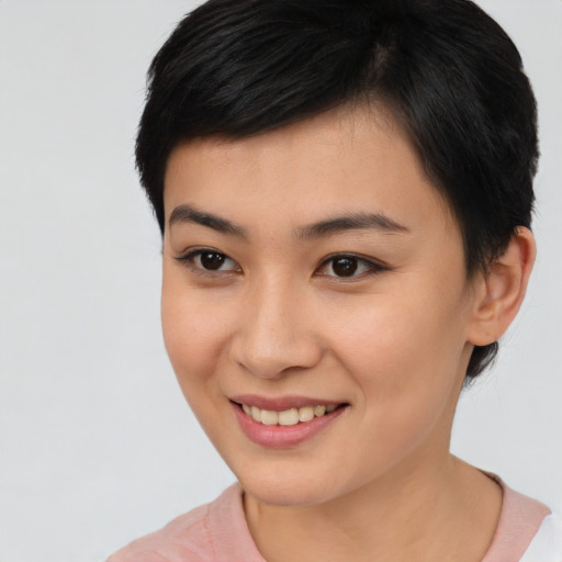 Joyful asian young-adult female with short  brown hair and brown eyes
