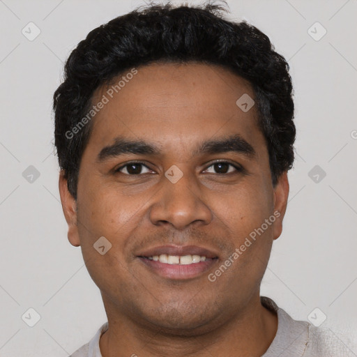 Joyful black young-adult male with short  black hair and brown eyes