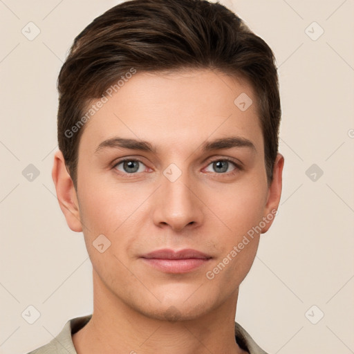 Joyful white young-adult male with short  brown hair and grey eyes