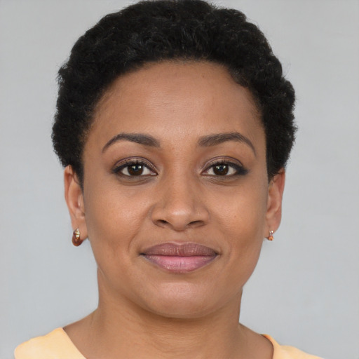 Joyful black young-adult female with short  brown hair and brown eyes