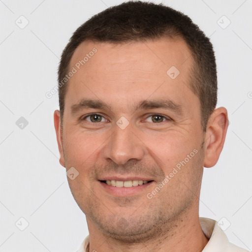 Joyful white young-adult male with short  brown hair and brown eyes