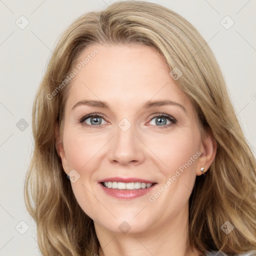 Joyful white adult female with medium  brown hair and blue eyes