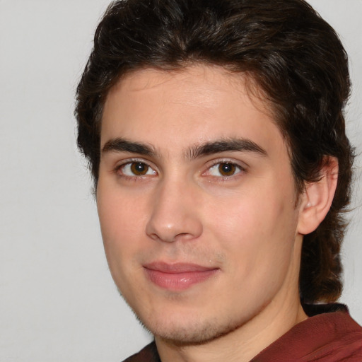 Joyful white young-adult male with medium  brown hair and brown eyes