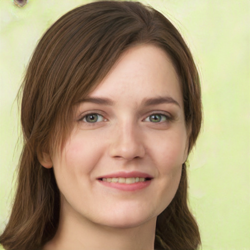 Joyful white young-adult female with long  brown hair and green eyes