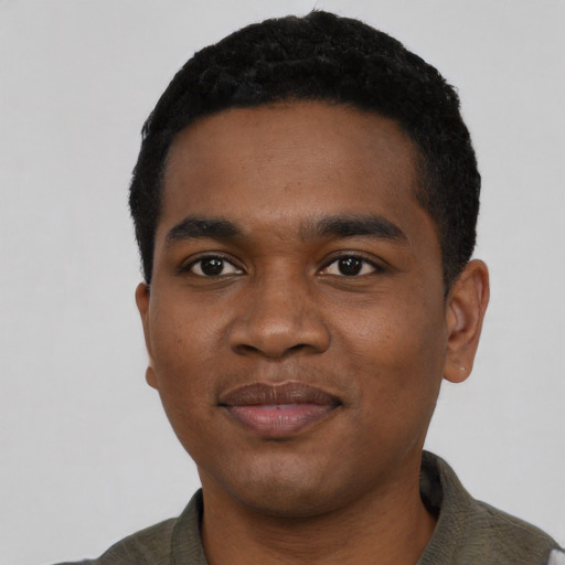 Joyful black young-adult male with short  black hair and brown eyes