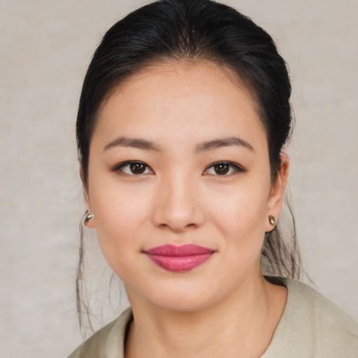 Joyful asian young-adult female with medium  brown hair and brown eyes
