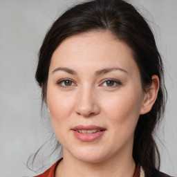 Joyful white young-adult female with medium  brown hair and brown eyes