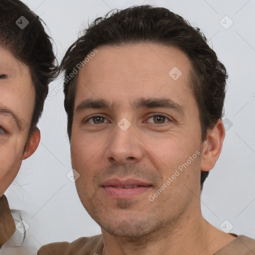 Joyful white adult male with short  brown hair and brown eyes