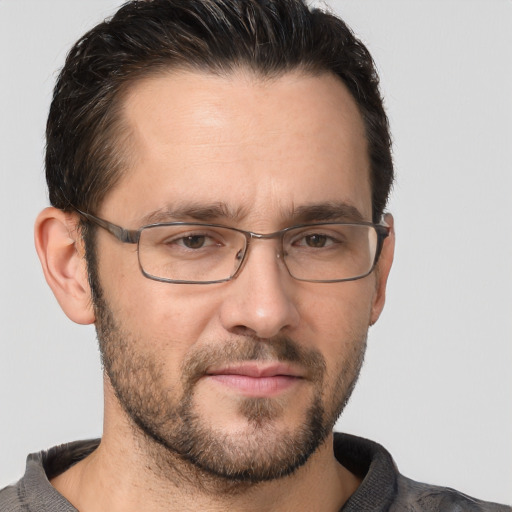 Joyful white adult male with short  brown hair and brown eyes