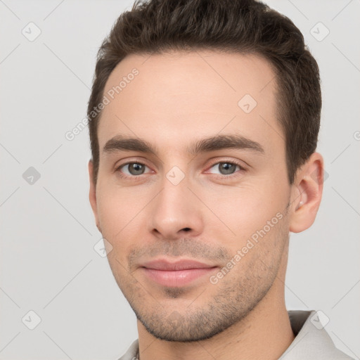 Joyful white young-adult male with short  brown hair and brown eyes