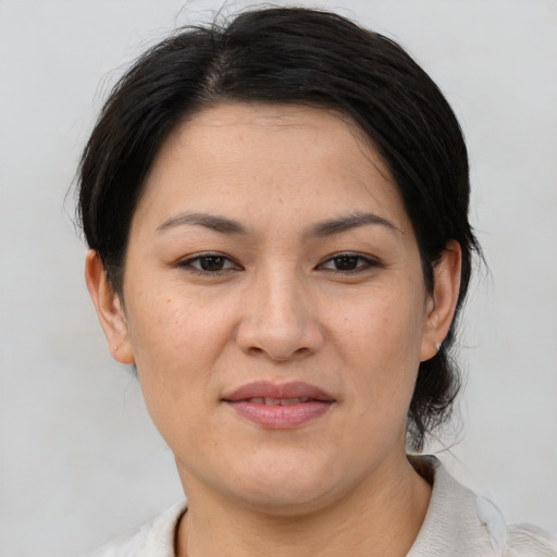 Joyful asian young-adult female with short  brown hair and brown eyes