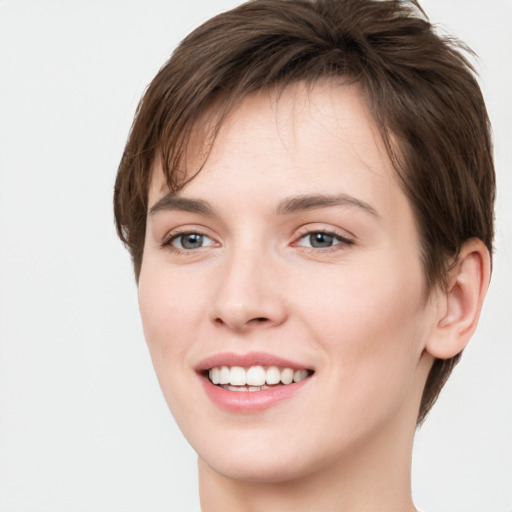 Joyful white young-adult female with short  brown hair and grey eyes