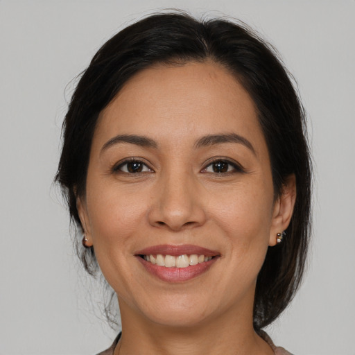 Joyful white adult female with medium  brown hair and brown eyes