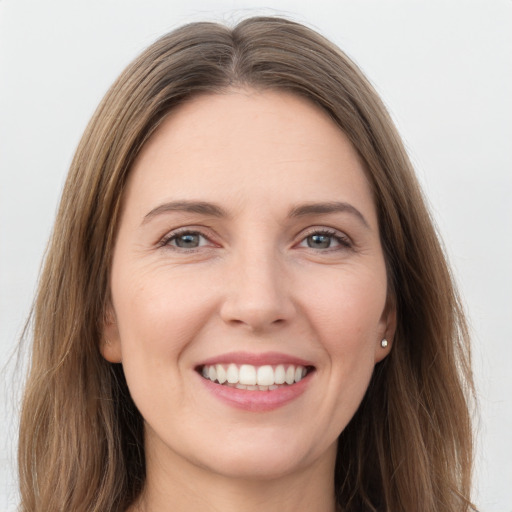 Joyful white young-adult female with long  brown hair and grey eyes