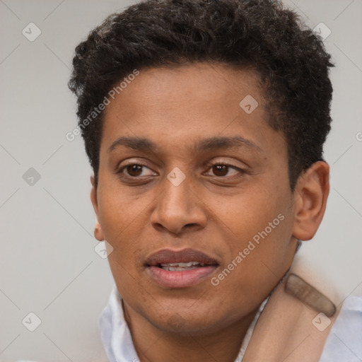 Joyful black young-adult male with short  brown hair and brown eyes